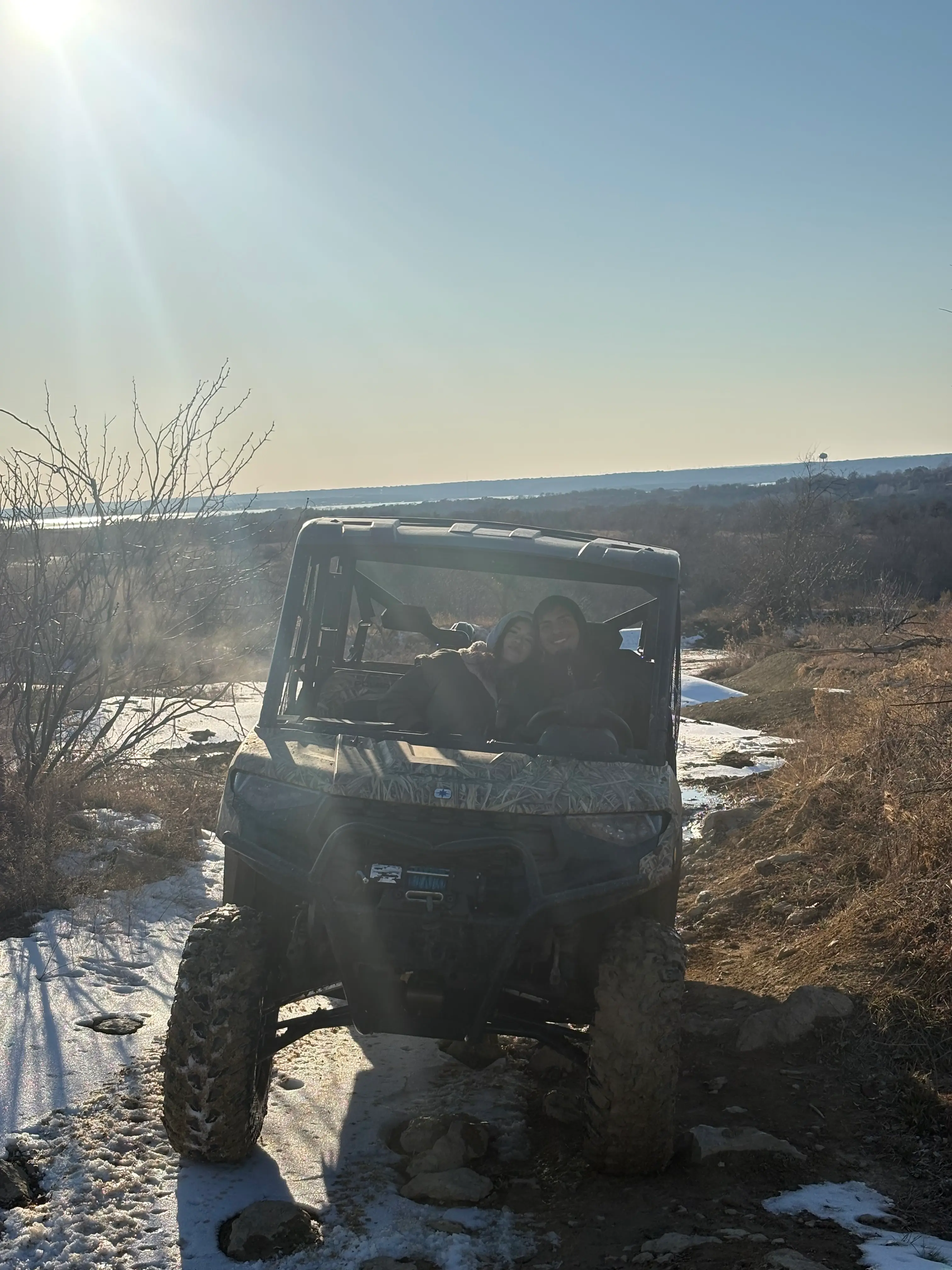 Couple riding a UTV through a Texas off-road trail
